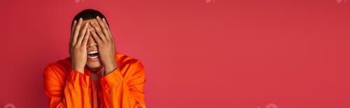 Preview: upset african american man in orange shirt obscuring face with hands on red, banner, copy space