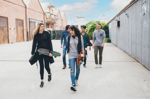 Preview: Group of friends skaters walking outdoors having fun chatting