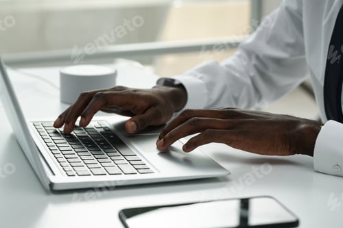 Preview: African American businessman typing on laptop