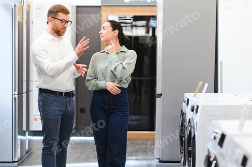 Preview: Home Electronics Store Sales Consultant Comes to Assist a Young Woman.