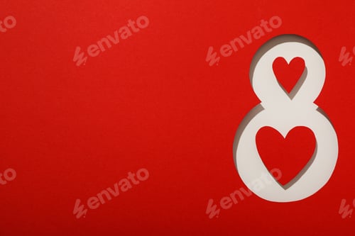 Preview: Number eight cut out of paper on a red background