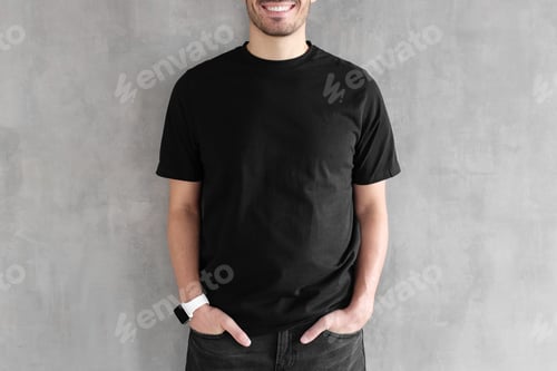Preview: Hotizontal portrait of young man wearing blank black t-shirt and jeans