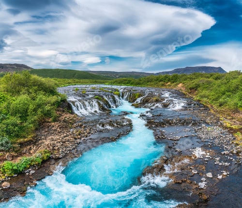 Preview: Vibrant bruarfoss waterfall flowing through rocky and wilderness in summer at Iceland