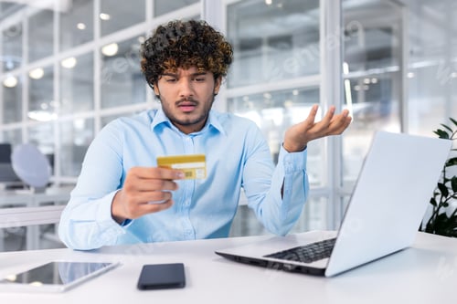 Preview: Problems with the account, payment, transaction. A young Muslim businessman is sitting in the