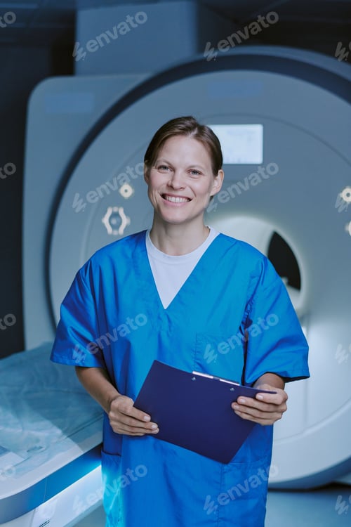 Preview: Portrait of Caucasian Young Adult Woman Smiling While Holding Clipboard in Mri Room
