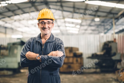 Preview: Senior high skill professional engineer male worker in heavy industry factory standing confident.