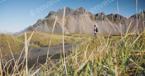 Preview: Morning scene of female traveler exploring Stokksnes cape with Vestrahorn (Batman Mountain) on