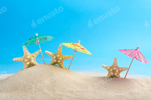 Preview: Starfish skeletons and cocktail umbrellas on beach sand with blue background.