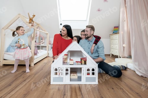 Preview: Happy family with three daughters in nursery