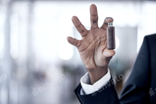 Preview: These things are so efficient. Cropped shot of an african businessman holding up a usb.