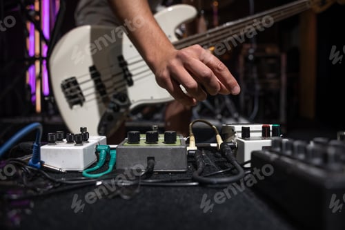 Preview: Close-up set of distortion effect pedals for guitar on stage.