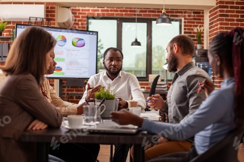 Preview: Diverse coworkers discussing in office