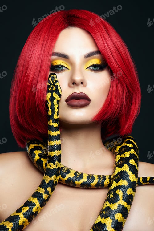 Preview: Beautiful woman with red hair and a yellow python snake around her neck. Professional Makeup
