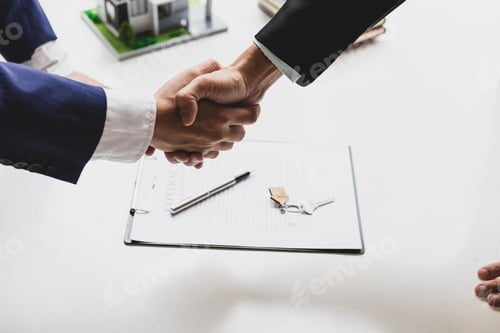 Preview: Businessman and real estate agent shaking hands after negotiating home purchase agreement.