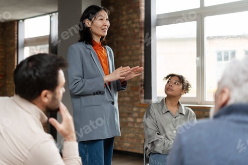 Preview: Asian businesswoman leading a business meeting with her team
