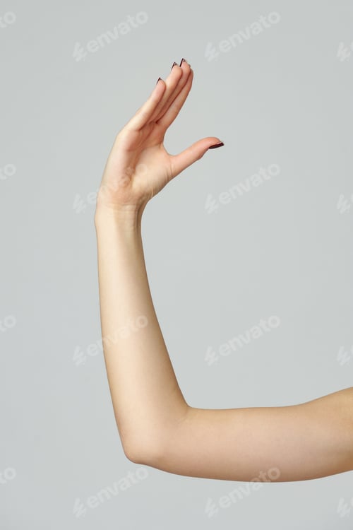 Preview: Young woman hand gesture on gray background