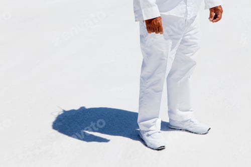 Preview: A man in white overalls,a race official timekeeper at a car racing event on salt flats