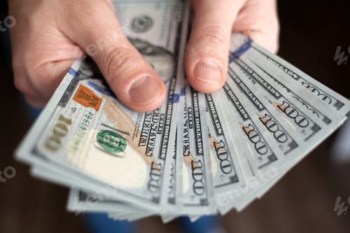Preview: Close up male hand Counting and holding money us dollar.