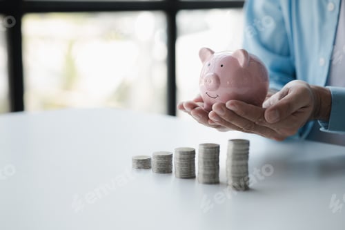Preview: Person with pile of coins and piggy bank, money saving concept for future use and financial stabilit