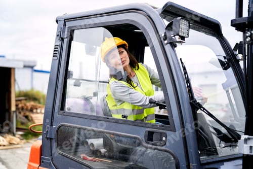 Preview: Adult caucasian woman driving a forklift
