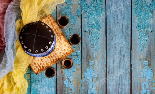 Preview: Jewish Passover attributes in composition a cup full of wine and passover matzah