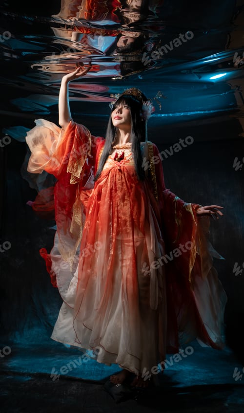 Preview: Asian woman in traditional red costume with golden details