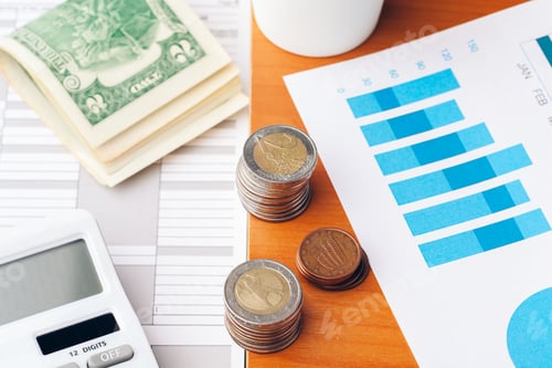 Preview: Close up of a calculator and coins on a business background