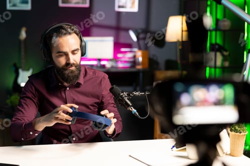 Preview: Audiophile reviewing wireless headphones, filming with professional camera