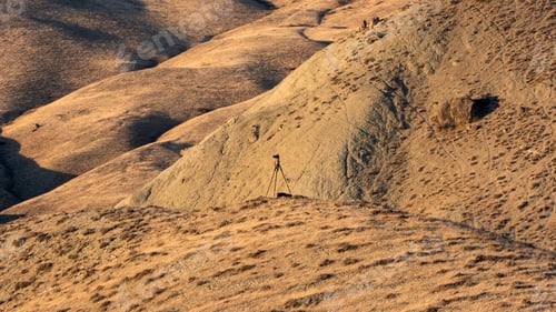 Preview: Camera and tripod on top of a mountain