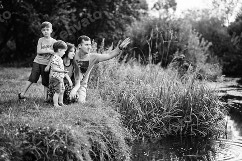 Preview: Happy young family: mother, father, two children son on nature having fun.