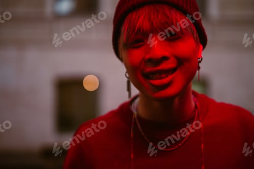 Preview: Asian boy wearing hat smiling wile listening music