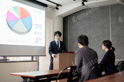 Preview: Asian businessman giving a presentation at a conference