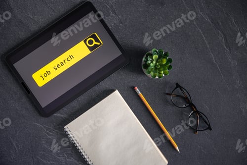 Preview: Top view of digital tablet with search job on screen on a table.