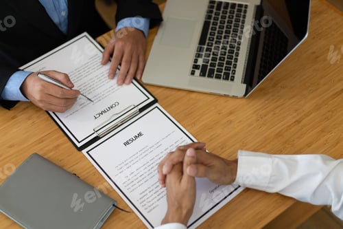 Preview: Job applicant holding resume is discussing and interviewing with manager in the recruitment office.