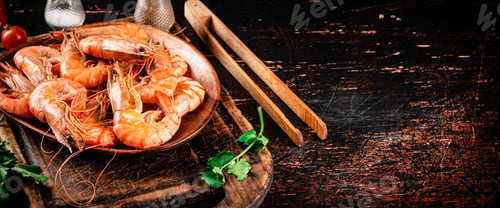 Preview: Boiled shrimp in a plate on a cutting board with spices.