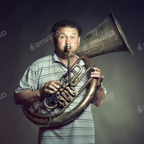 Preview: Portrait of an old man close up playing the trumpet