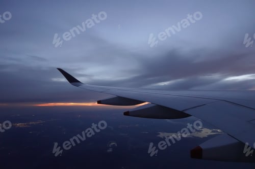 Preview: Wing of aircraft flying above the clouds