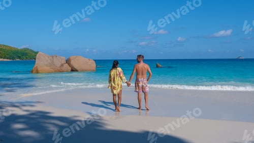 Preview: Anse Lazio Praslin Seychelles, a young couple of men and women on a tropical beach during vacation
