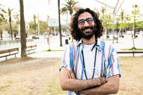 Preview: Portrait of happy hipster guy smiling wearing a shirt looking at camera and taking a selfie in the
