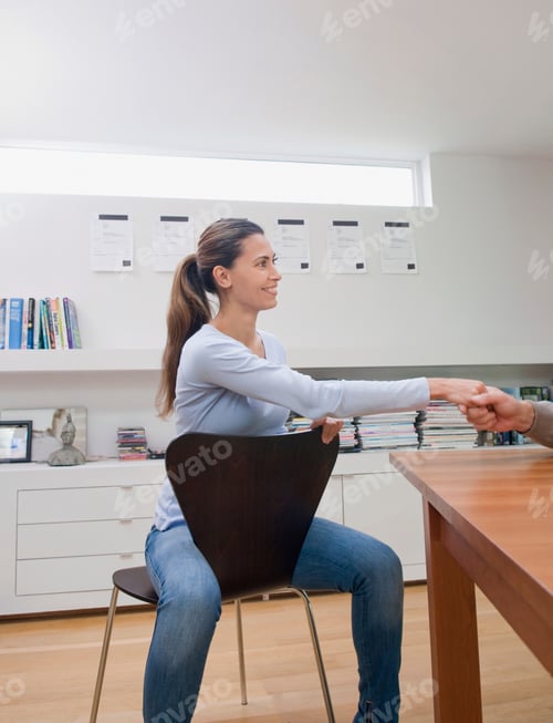 Preview: A female business woman shaking hands.