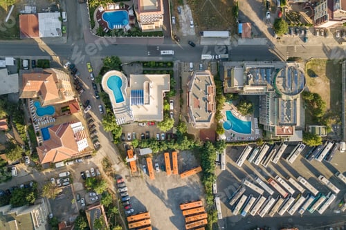 Preview: Top down aerial view of hotels roofs, streets with parked cars and swimming pools