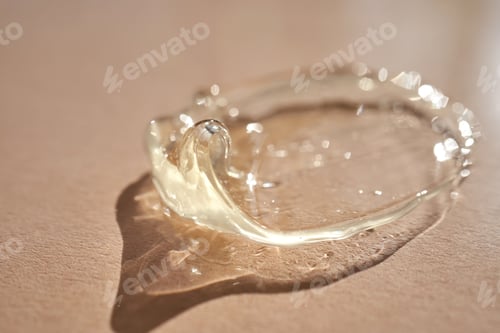 Preview: The texture of a yellow transparent gel cosmetic.