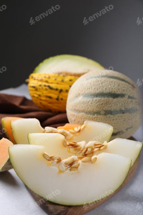 Preview: Tasty colorful ripe melons on light grey table