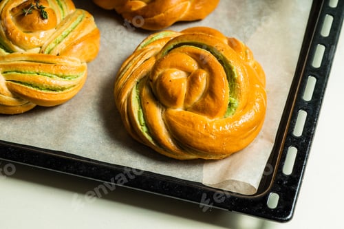 Preview: homemade buns with cream and pistachio cream decorated with thyme freshly baked for breakfast