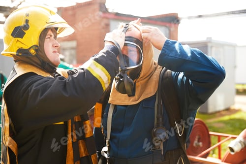 Preview: Firemen training, supervisor helping fireman with breathing apparatus at training facility