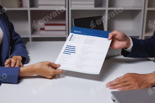 Preview: Applicant handing resume to interviewer during job meeting