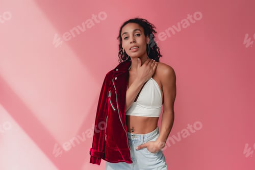 Preview: attractive black african american woman in stylish outfit on pink background