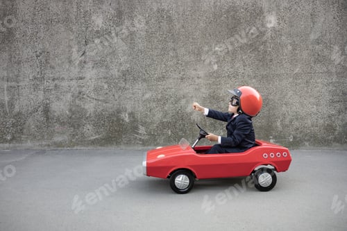 Preview: Funny businessman driving retro pedal car outdoor