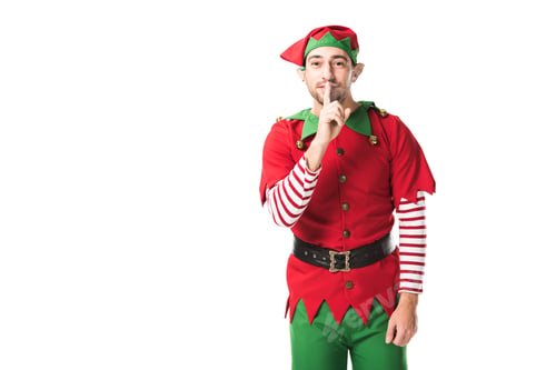 Preview: man in christmas elf costume showing hush silence sign and looking at camera isolated on white