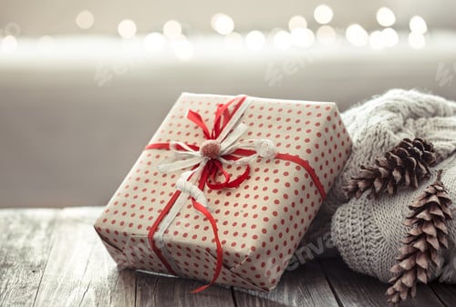 Preview: Gift Box with Ribbon and Pinecones on Table
